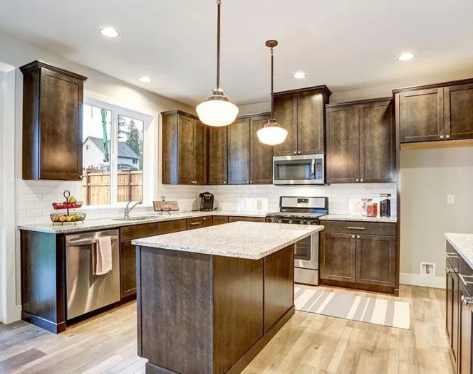 Brightly lit remodeled kitchen with wooden cupboards and island in Green Bay, WI