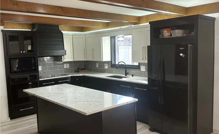 A newly remodeled kitchen with black base cabinets