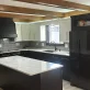 A newly remodeled kitchen with black base cabinets